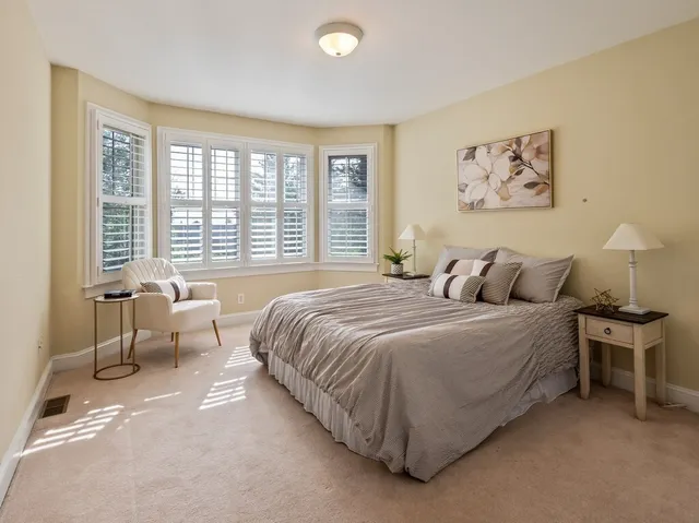 a spacious bedroom with a bed and a couch