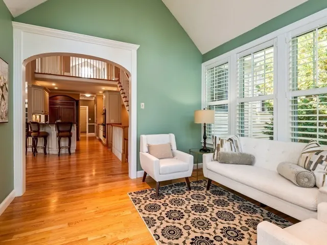 a living room with furniture and floor to ceiling windows