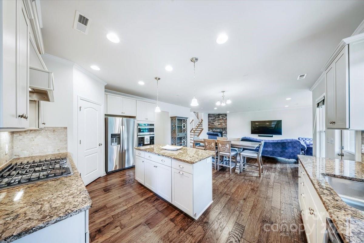 5366 Meadowcroft Way Fort Mill, SC 29708 - Photo 15 of 46 a living room with stainless steel appliances granite countertop furniture and a wooden floor