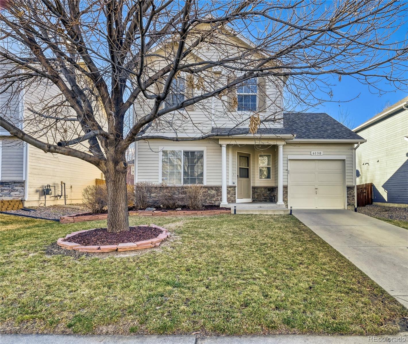 6130 Gorham Street Frederick, CO 80530 - Photo 1 of 47 a house that has a tree in front of it