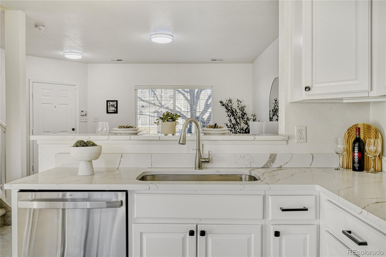 6130 Gorham Street Frederick, CO 80530 - Photo 17 of 47 a kitchen with cabinets a sink and appliances