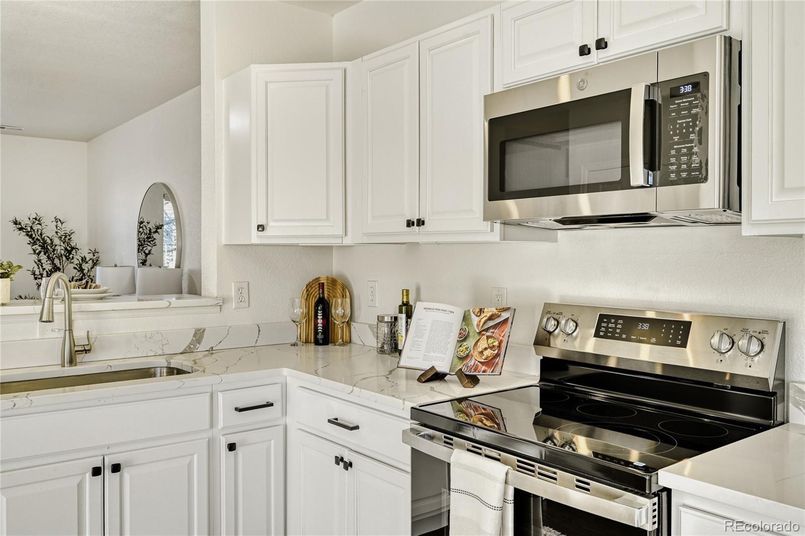 6130 Gorham Street Frederick, CO 80530 - Photo 18 of 47 a kitchen with granite countertop a stove and a sink