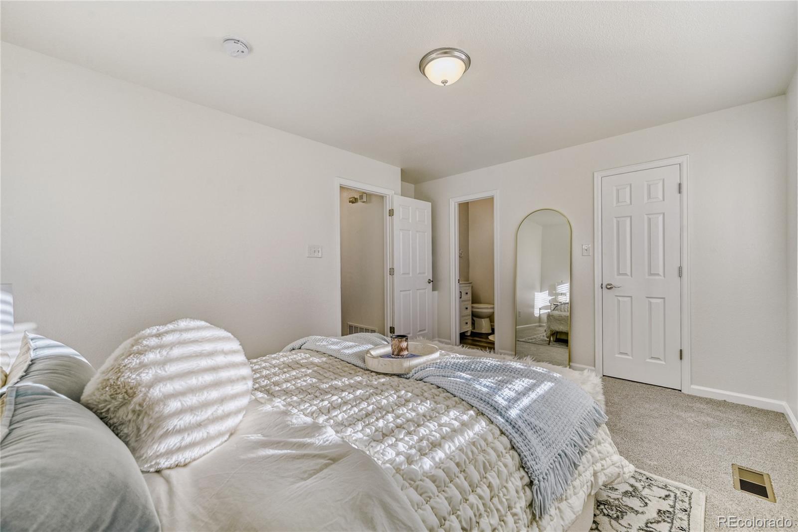 6130 Gorham Street Frederick, CO 80530 - Photo 26 of 47 a bedroom with a bed and a painting on the wall