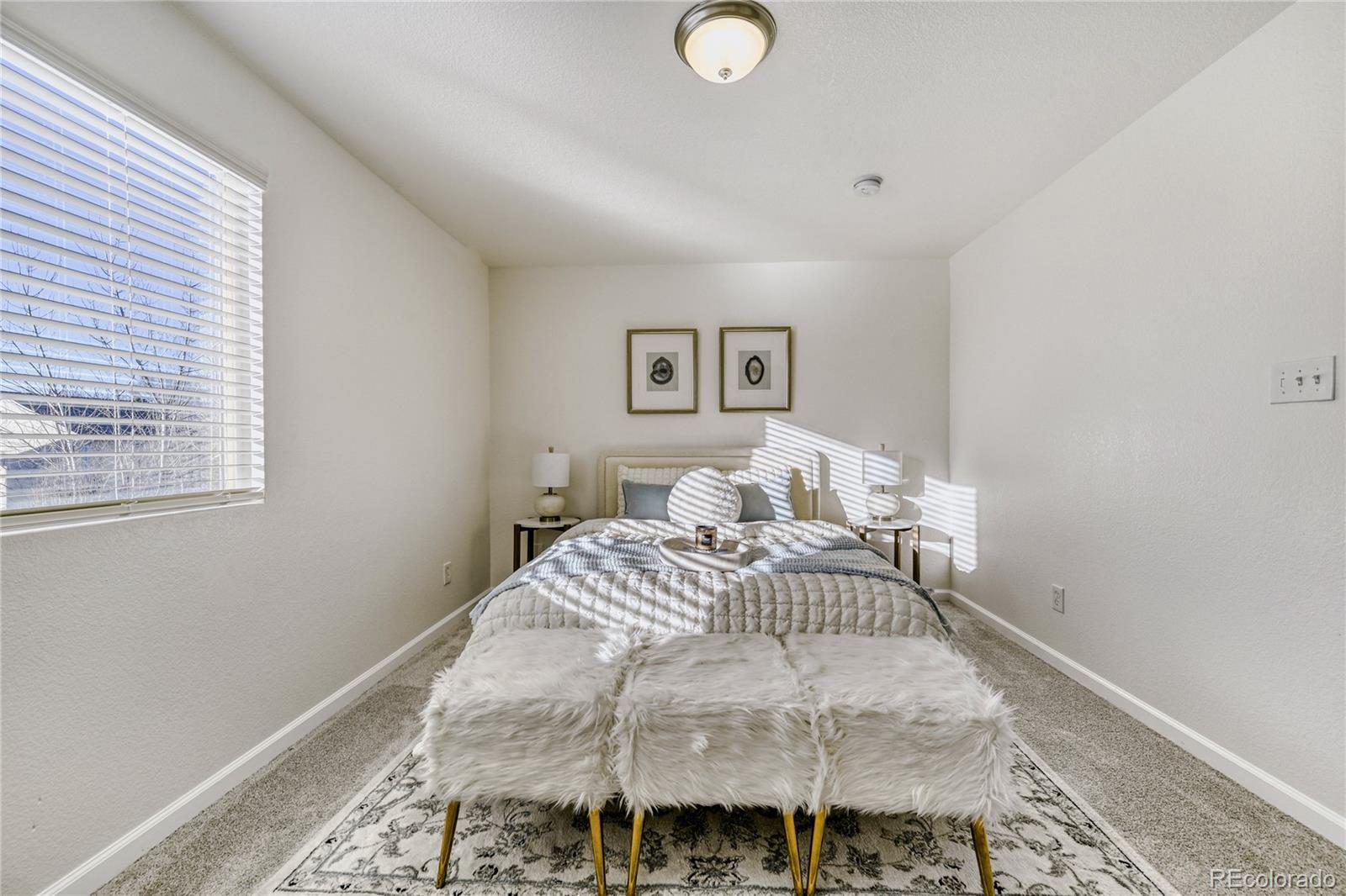6130 Gorham Street Frederick, CO 80530 - Photo 27 of 47 a bedroom with a bed and wooden floor