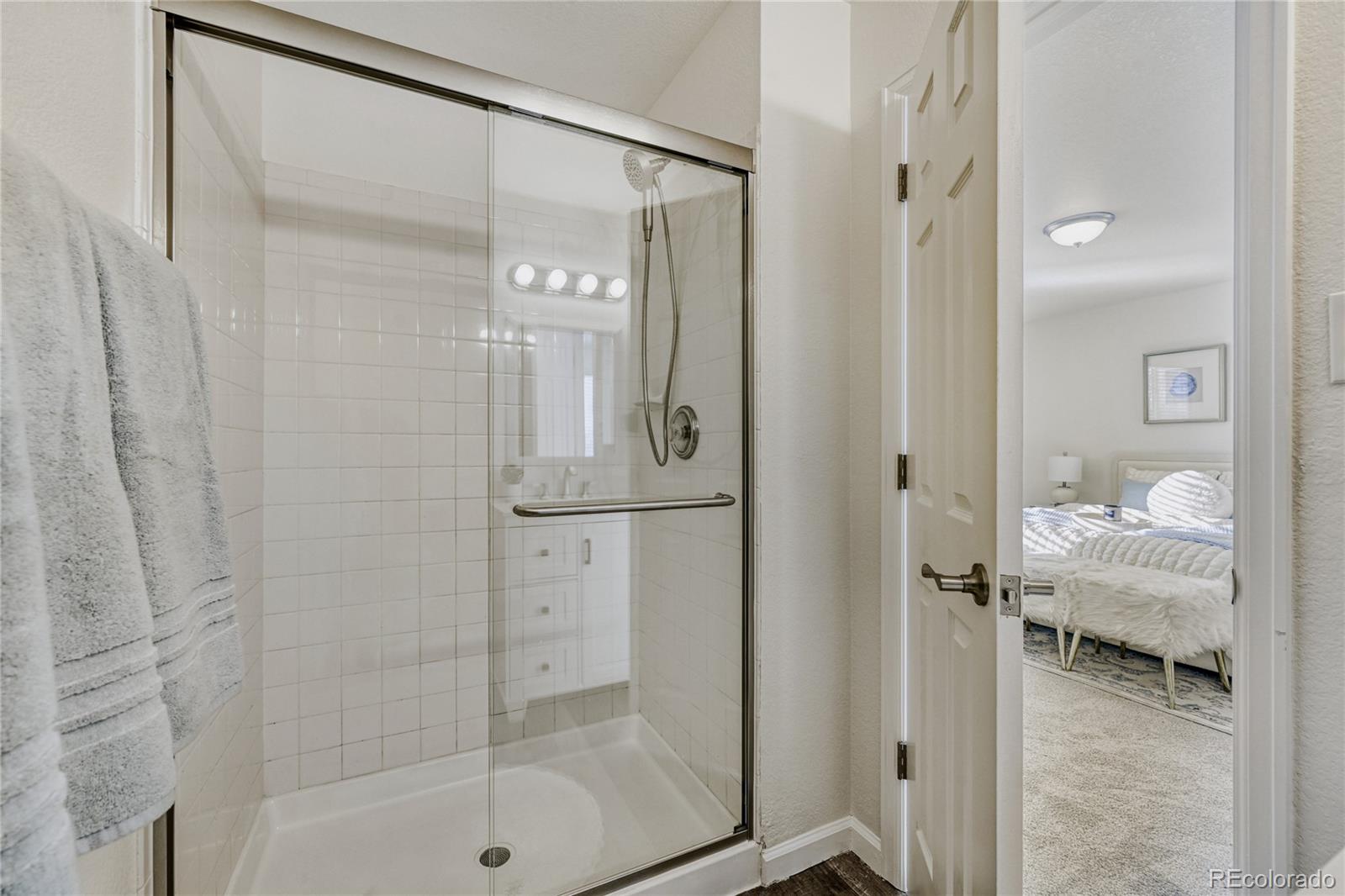 6130 Gorham Street Frederick, CO 80530 - Photo 29 of 47 a bathroom with a glass shower door