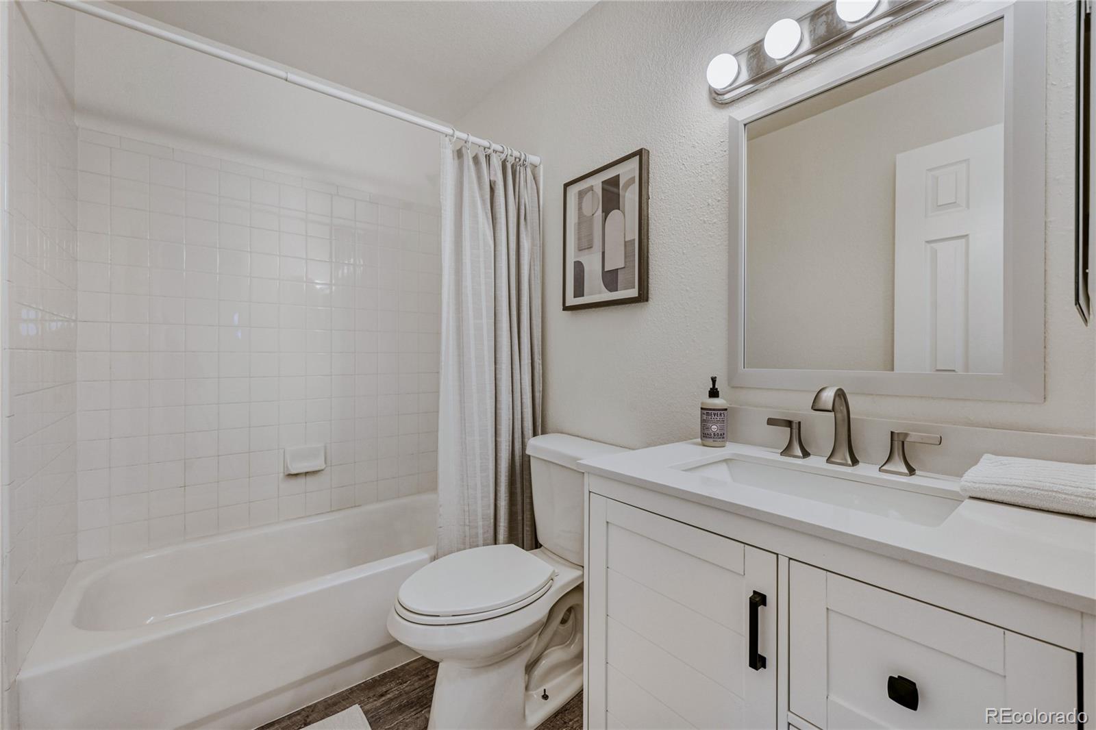6130 Gorham Street Frederick, CO 80530 - Photo 38 of 47 a bathroom with a sink a toilet and shower
