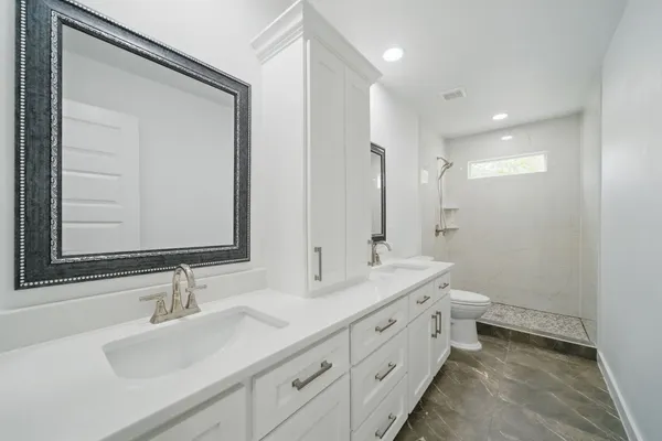 a bathroom with double sink and a mirror