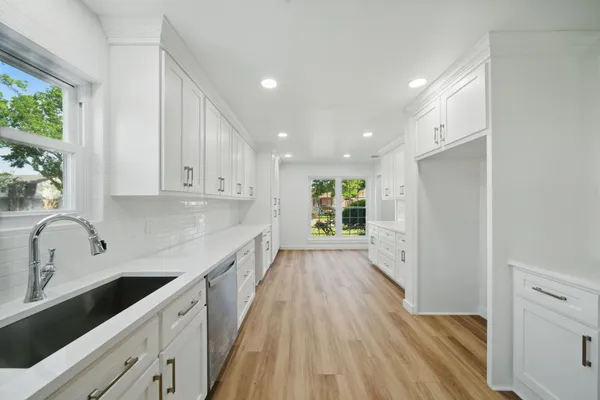 a kitchen with a sink a window and appliances