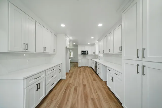 a kitchen with white cabinets