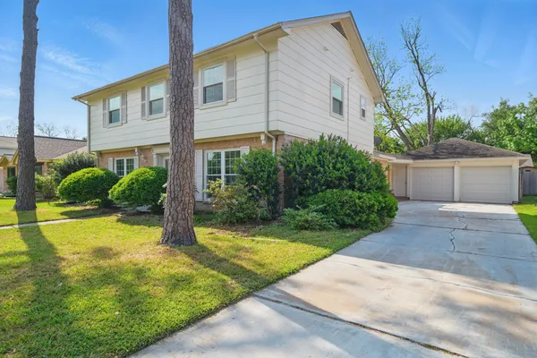 a view of a house with backyard and plants