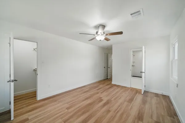 a view of an empty room with wooden floor