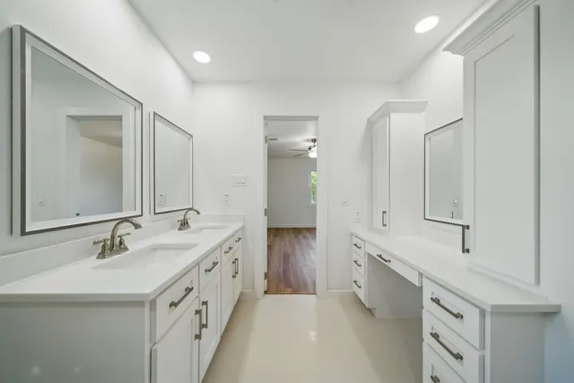 a spacious bathroom with a double vanity sink mirror and double