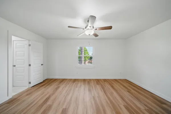 wooden floor in an empty room with a window