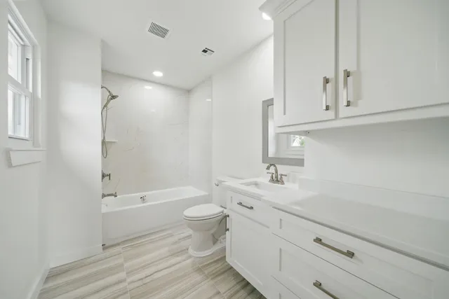 a bathroom with a sink a toilet and bathtub