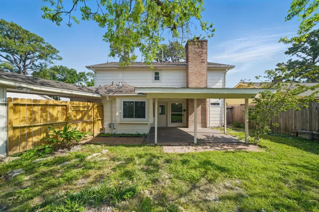 a view of house with a yard