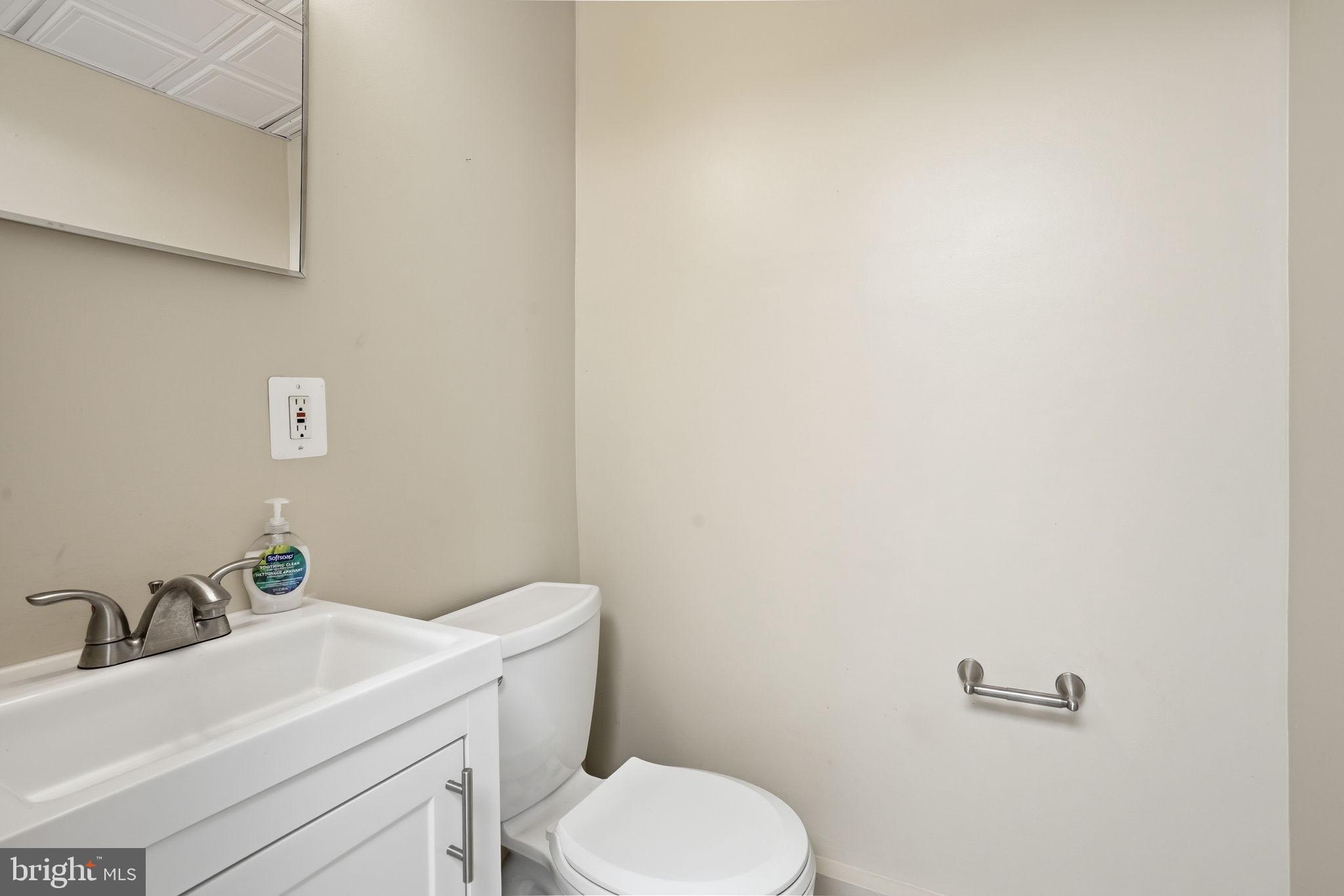 107 West Fort Avenue Baltimore, MD 21230 - Photo 11 of 34 a bathroom with a sink a toilet and mirror