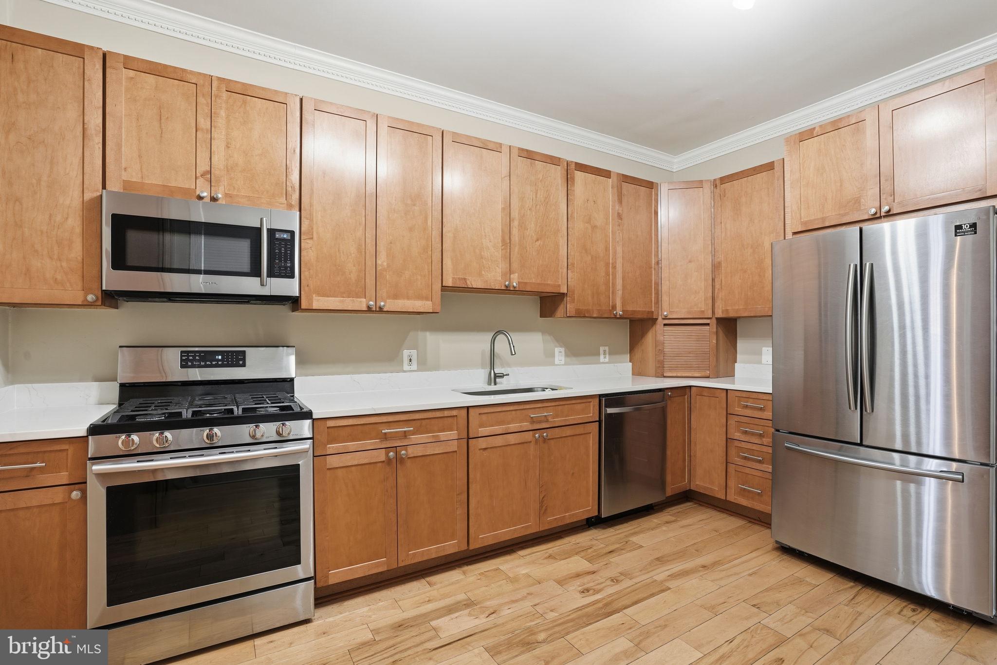 107 West Fort Avenue Baltimore, MD 21230 - Photo 13 of 34 a kitchen with cabinets stainless steel appliances and a window
