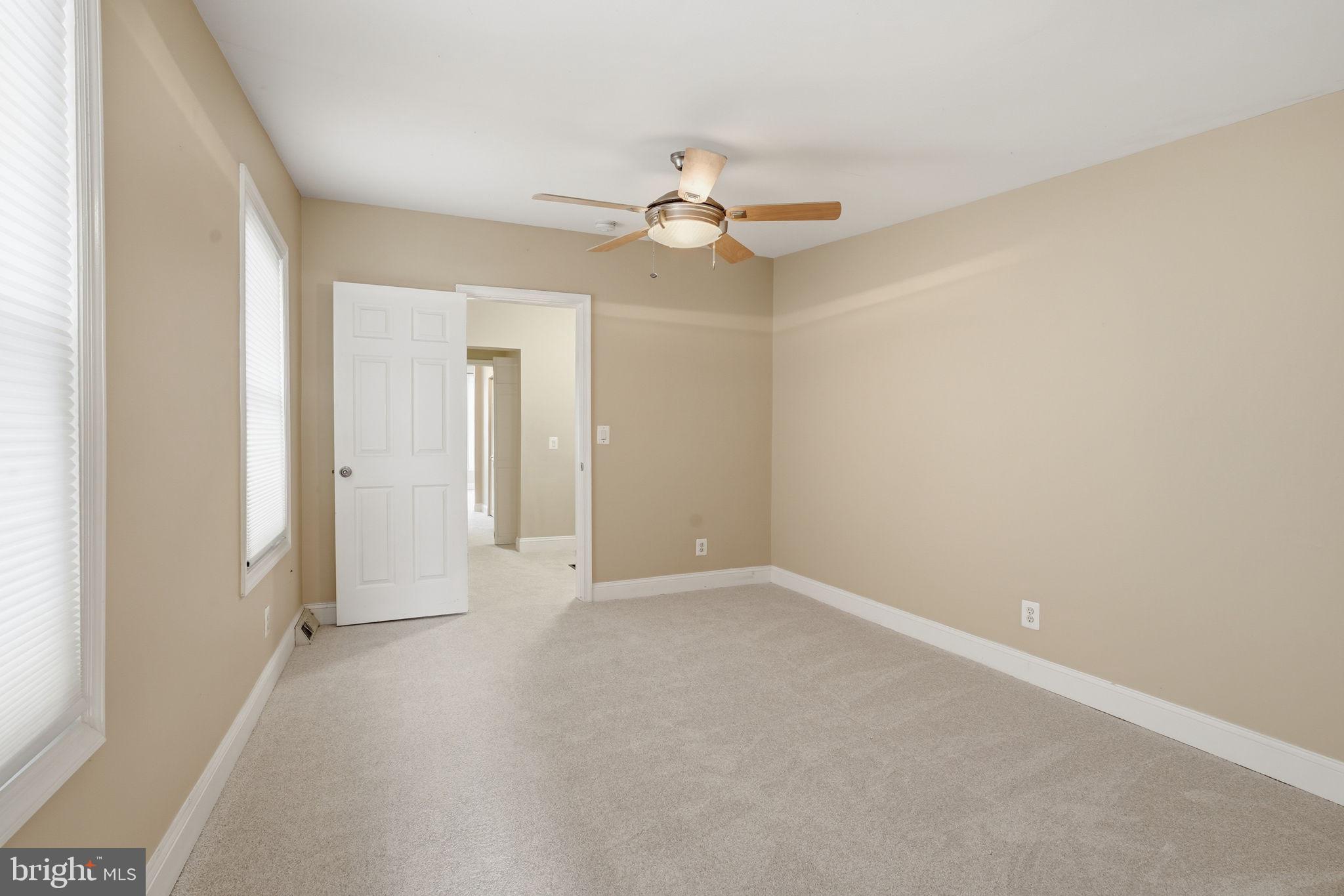 107 West Fort Avenue Baltimore, MD 21230 - Photo 18 of 34 an empty room with a ceiling fan and a window