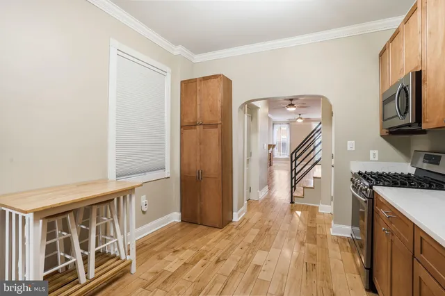 a kitchen with cabinets stainless steel appliances and a window