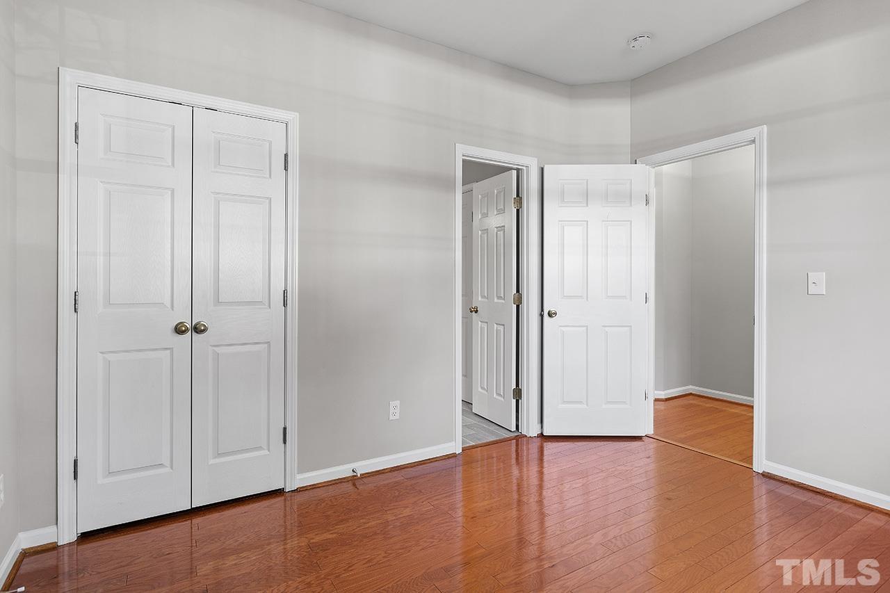 8516 Micollet Court Raleigh, NC 27613 - Photo 13 of 26 a view of empty room with wooden floor