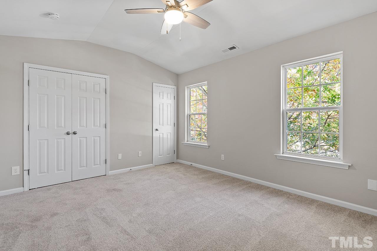 8516 Micollet Court Raleigh, NC 27613 - Photo 18 of 26 an empty room with windows and fan