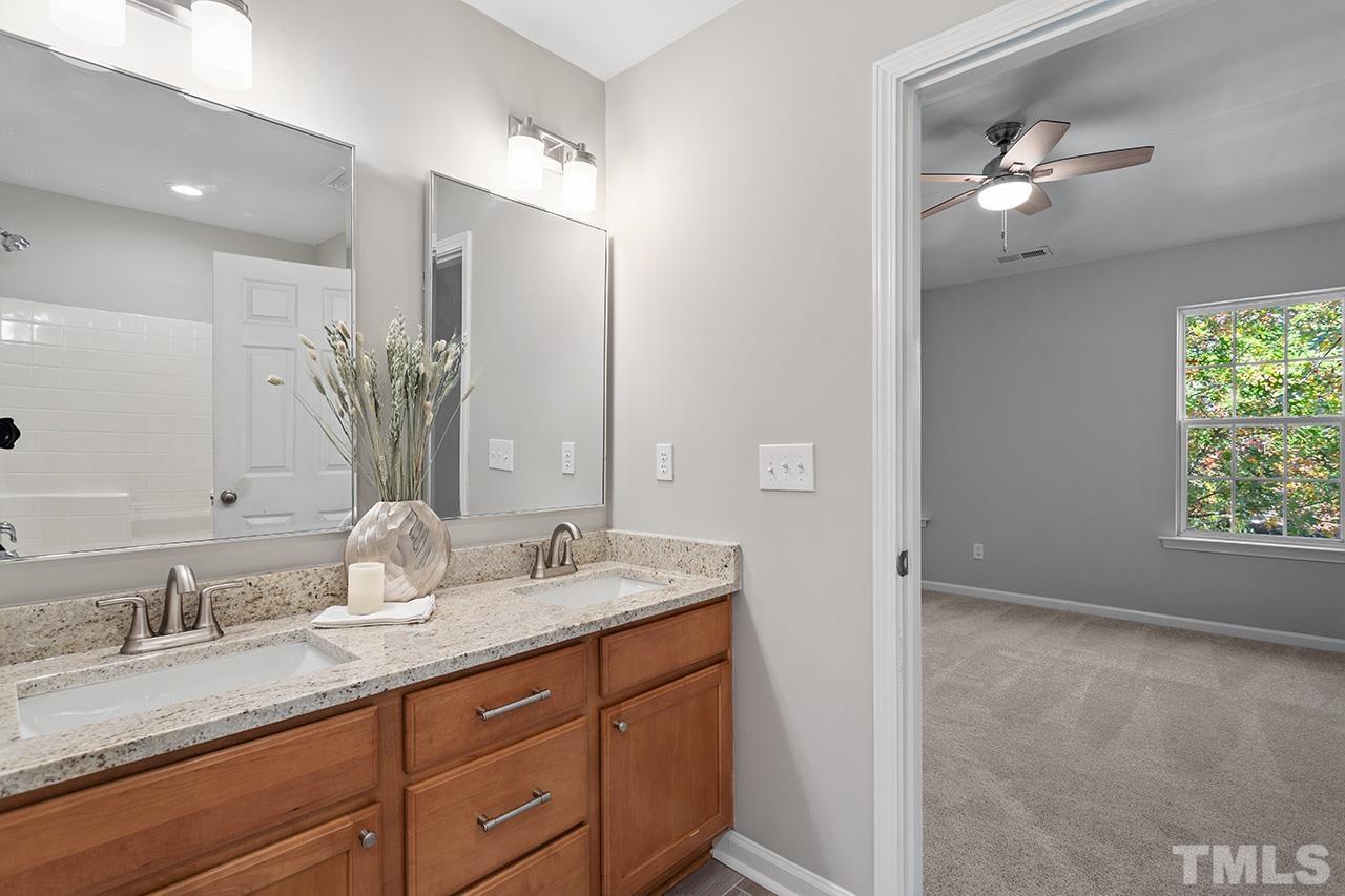 8516 Micollet Court Raleigh, NC 27613 - Photo 20 of 26 a bathroom with double vanity sinks and a mirror