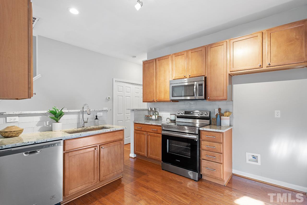8516 Micollet Court Raleigh, NC 27613 - Photo 2 of 26 a kitchen with a sink stove top oven and microwave