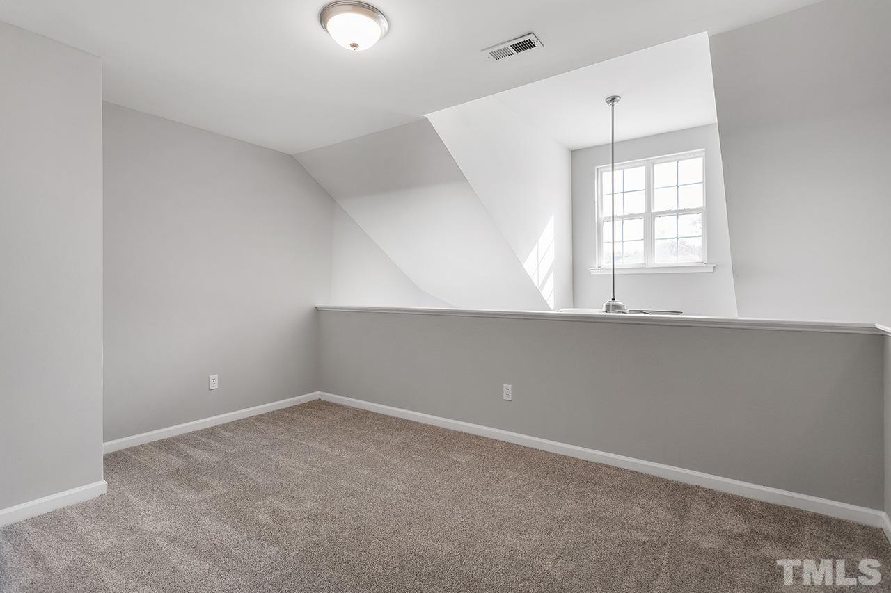 8516 Micollet Court Raleigh, NC 27613 - Photo 21 of 26 an empty room with windows