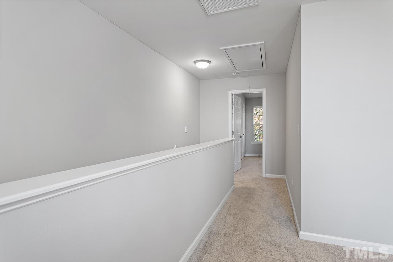 8516 Micollet Court Raleigh, NC 27613 - Photo 24 of 26 a view of a hallway with wooden floor