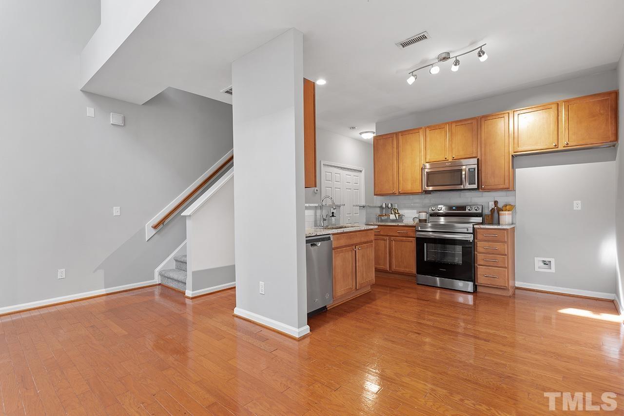 8516 Micollet Court Raleigh, NC 27613 - Photo 6 of 26 a kitchen with a refrigerator and a sink