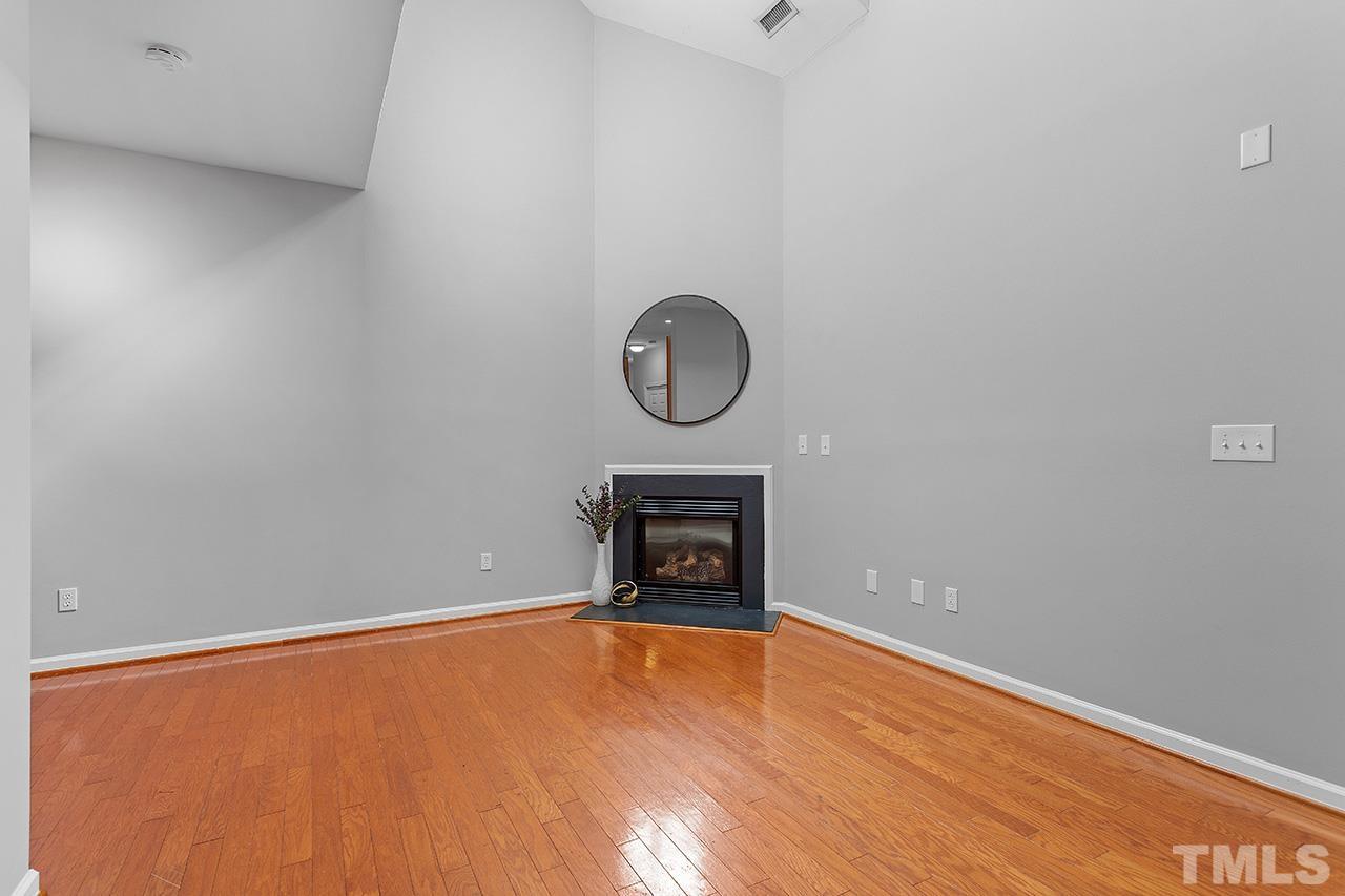 8516 Micollet Court Raleigh, NC 27613 - Photo 8 of 26 a room with a fireplace and a window
