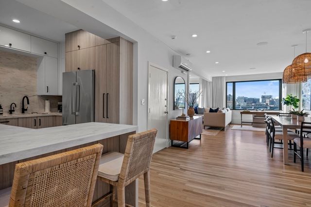 a large kitchen with a table and chairs