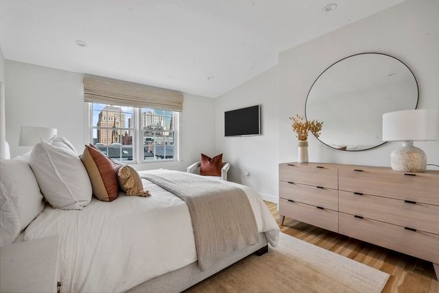 a bedroom with bed and a large window