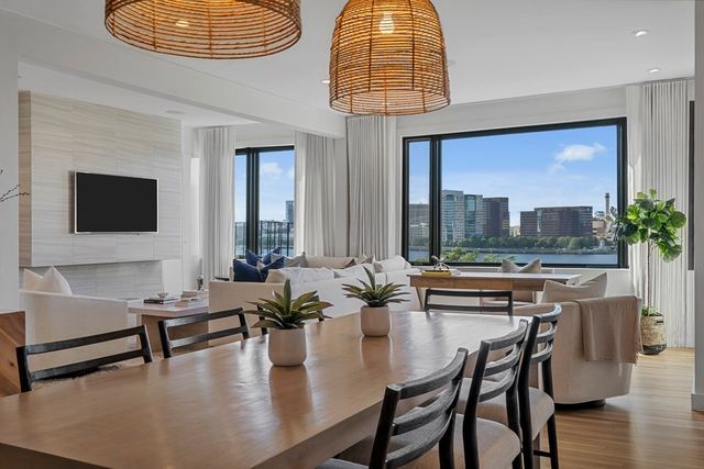 a living room with fireplace furniture and a large window