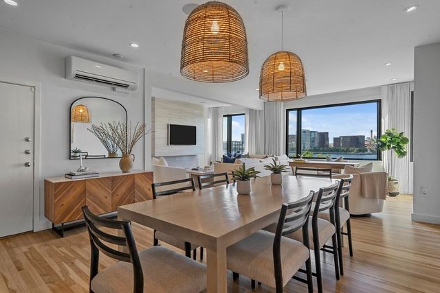 a dining hall with furniture a window and wooden floor