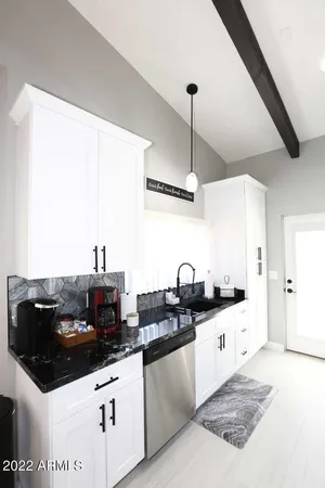 a kitchen with stainless steel appliances kitchen island granite countertop a sink and cabinets