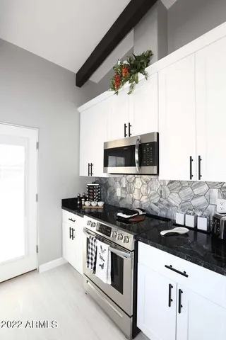 a kitchen with stainless steel appliances a sink and a stove