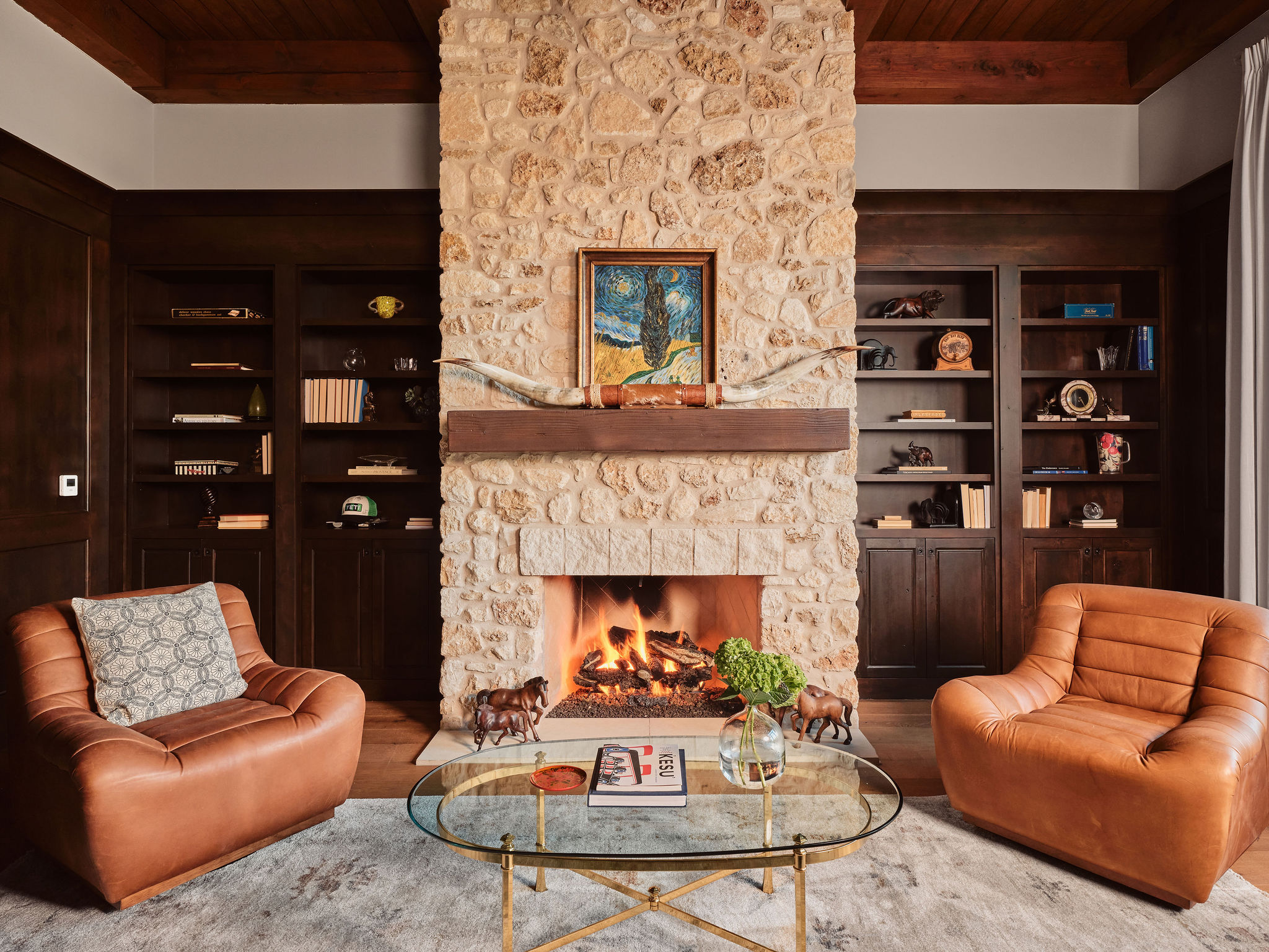 3667 Stoneridge Road Austin, TX 78746 - Photo 24 of 40 The warm fireplace and built in bookshelves create a lodge feel, perfect for nightcaps and deep conversations.