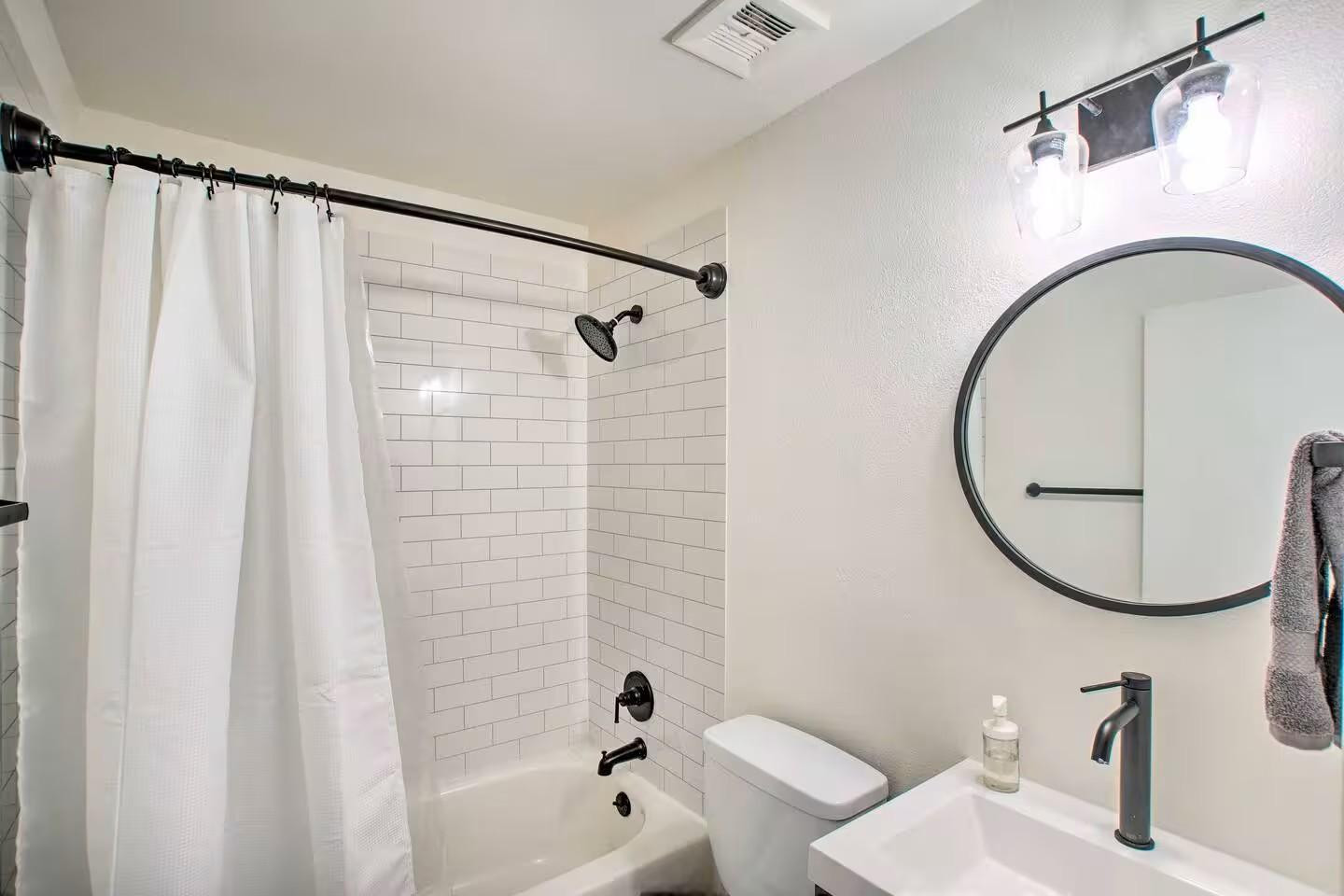 1233 East Marny Road Tempe, AZ 85288 - Photo 10 of 20 a bathroom with a sink a mirror a toilet and a shower