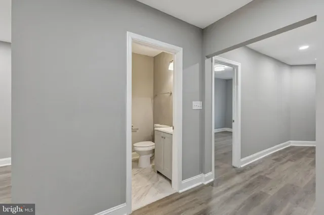 a bathroom with a toilet and a glass door