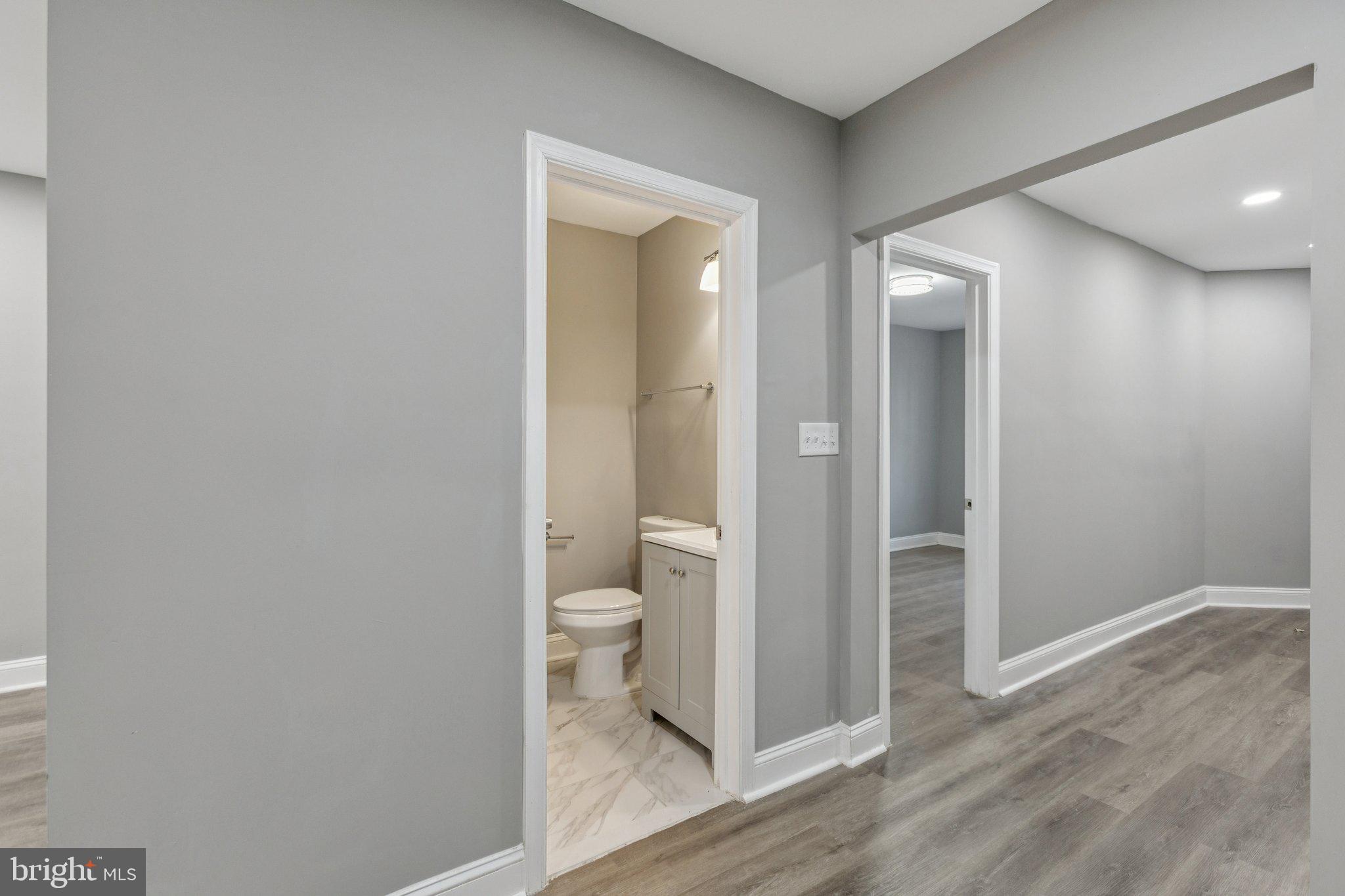 405 34th Street Southeast, Unit 2 Washington, DC 20019 - Photo 7 of 13 a bathroom with a toilet and a glass door