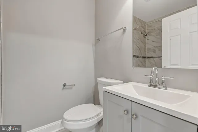 a bathroom with a sink toilet and vanity