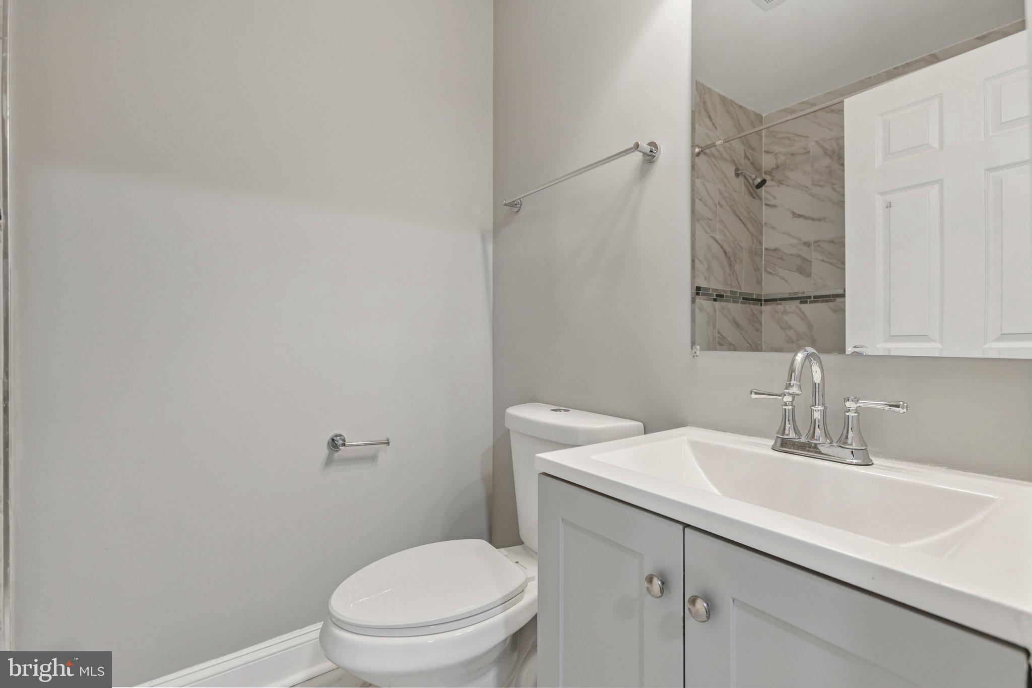 405 34th Street Southeast, Unit 2 Washington, DC 20019 - Photo 8 of 13 a bathroom with a sink toilet and vanity