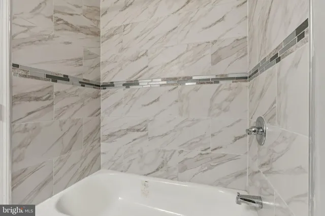 a bathroom with a shower and a bathtub