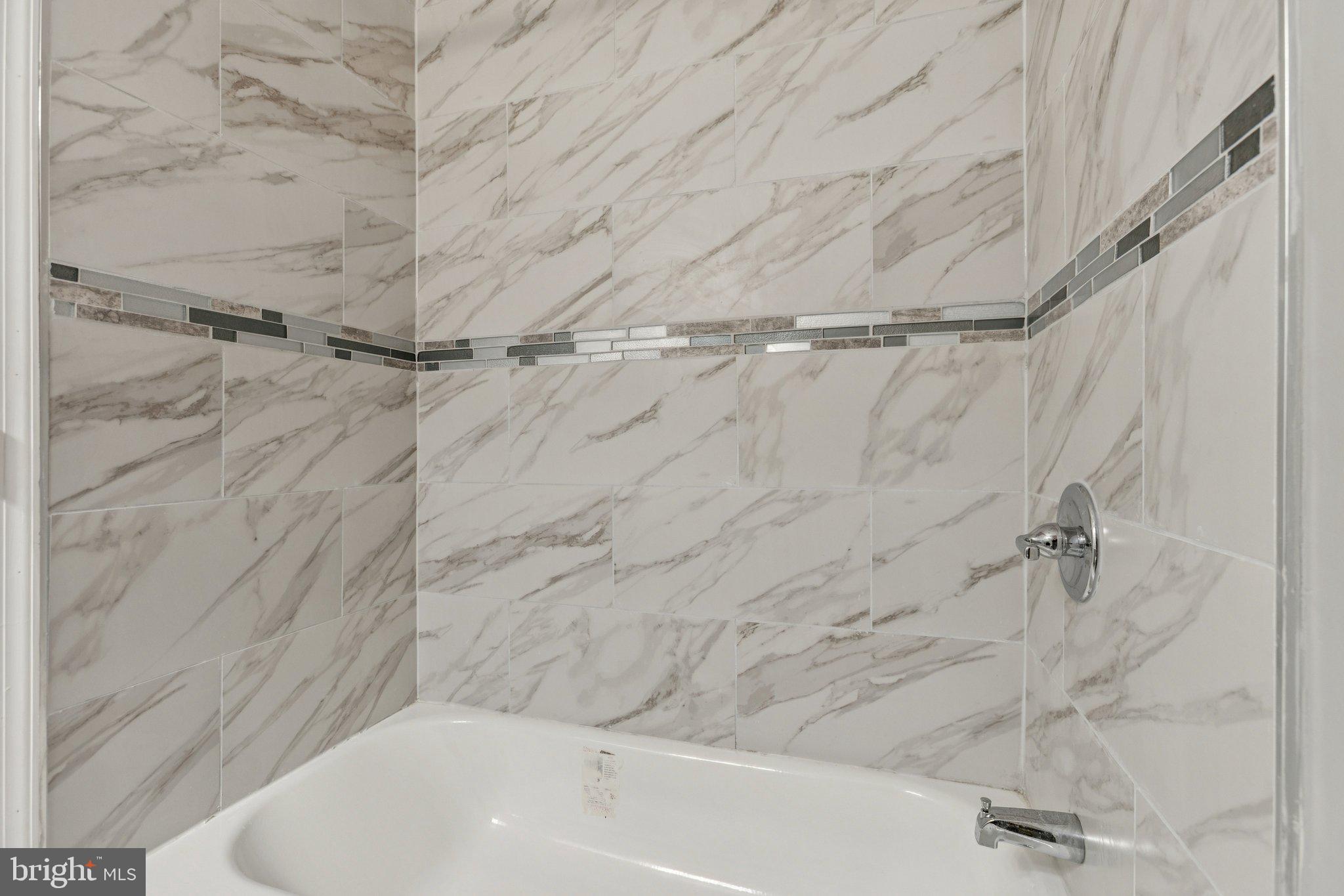 405 34th Street Southeast, Unit 2 Washington, DC 20019 - Photo 9 of 13 a bathroom with a shower and a bathtub
