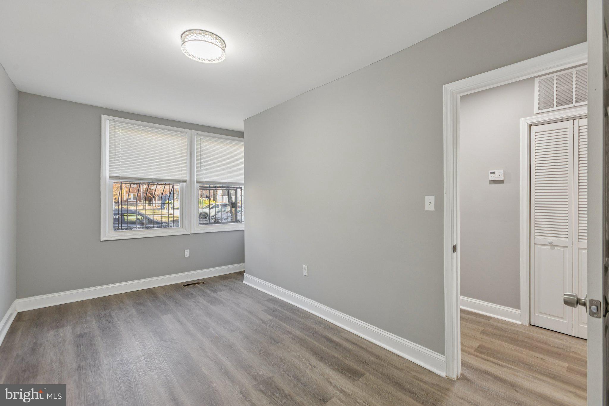 405 34th Street Southeast, Unit 2 Washington, DC 20019 - Photo 10 of 13 an empty room with wooden floor and windows