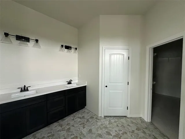 a bathroom with a tub sink and mirror