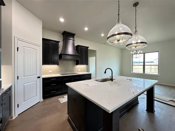a kitchen with kitchen island a counter space appliances and a center island