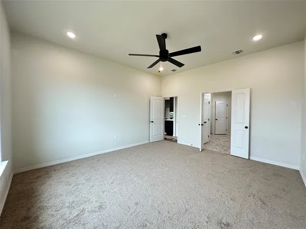 an empty room with a empty space and a ceiling fan