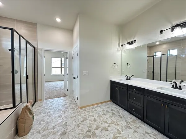 a spacious bathroom with a double vanity sink and a mirror